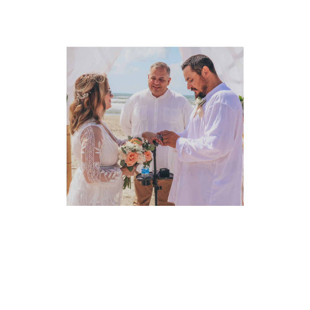 Pastor Rick Barrera with Texas Wedding Ministers officiating a beach wedding while the couple are giving each other their rings