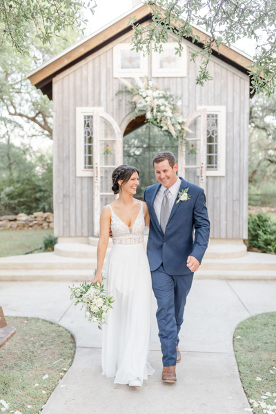 Texas Wedding Ministers Couple walking together and holding hands at Firefly Farms
