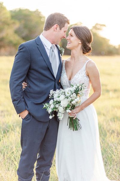 Texas Wedding Ministers couple touching foreheads and smiling in a field at Firefly Farms