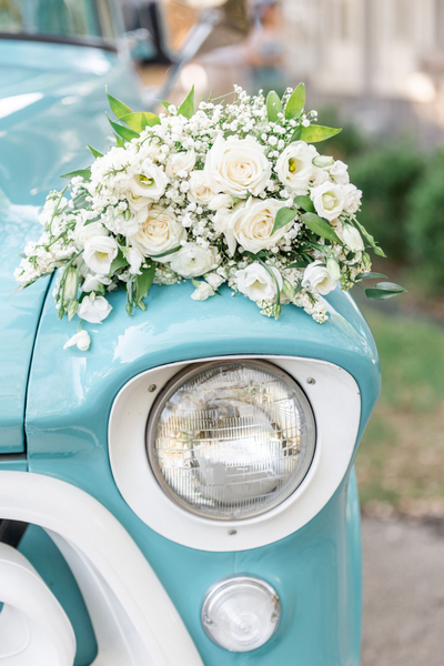 Bridal bouquet on vintage car at Firefly Farms