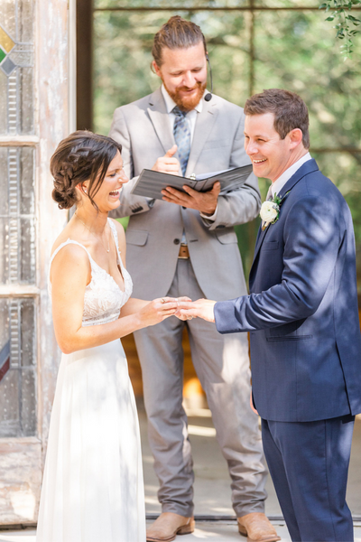 Texas Wedding Ministers couple laughing during ceremony with Pastor Richard Schweinsberg.