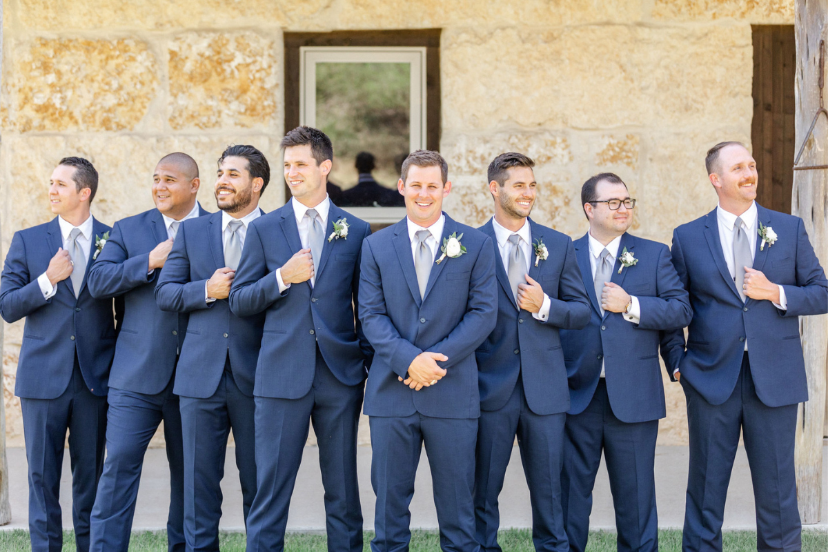 Texas Wedding Ministers Groom standing with groomsmen posing and laughing