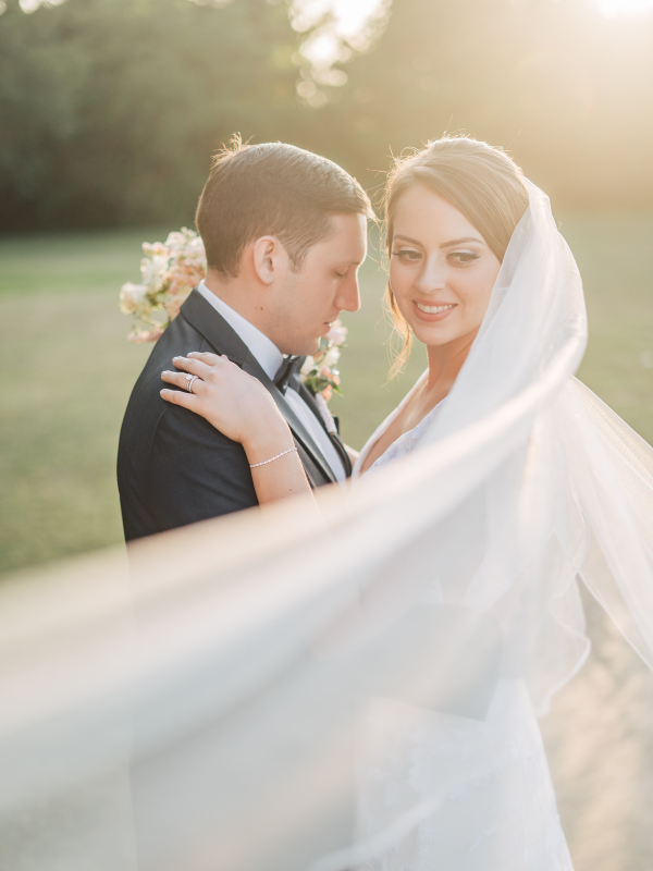 Texas Wedding Ministers couple posing for camera with veil